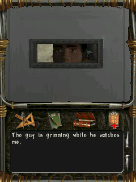 A grinning patient behind a cell door